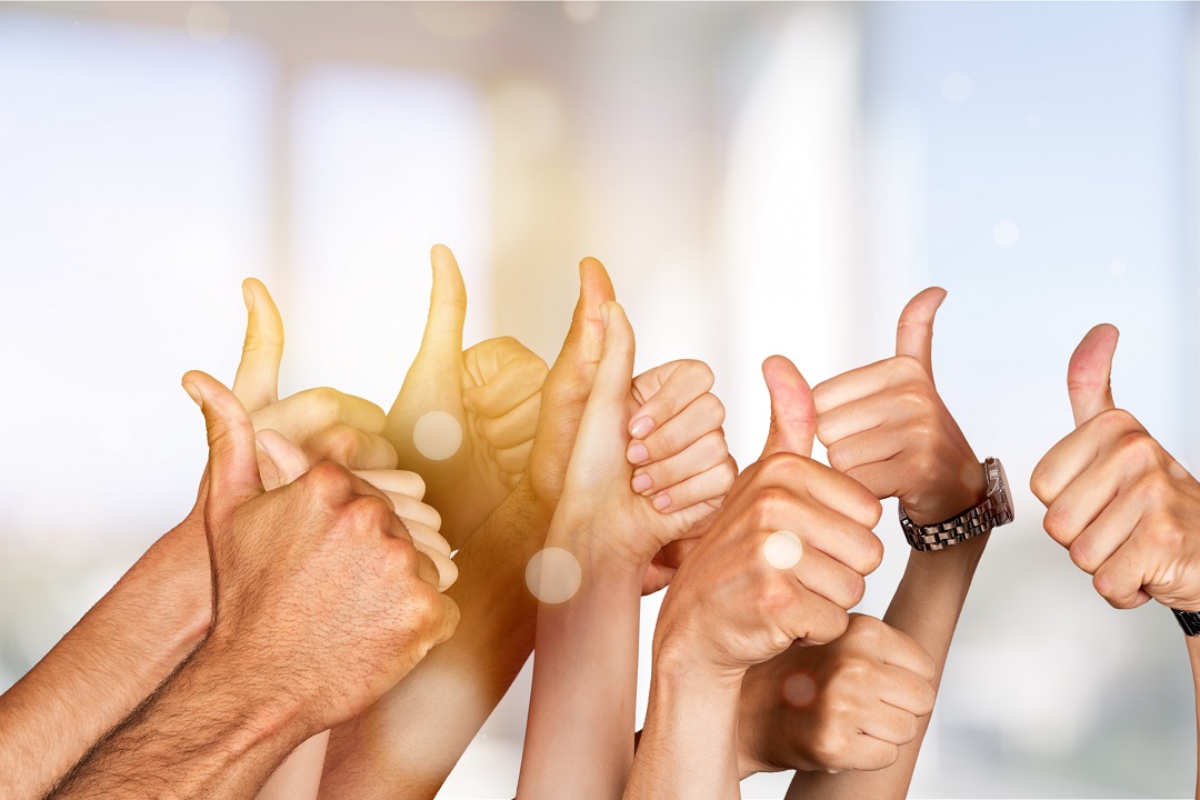 Group of people hands showing thumbs up signs on background